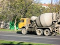 Car concrete mixer yellow rides on the road