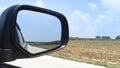 Car on the concrete road drive to nature. Focus to mirror view backside. Royalty Free Stock Photo