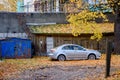 A car at courtyard, parked next to shed