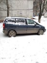 A car covered with first snow