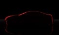 Car covered with a red cloth isolated on a black background Royalty Free Stock Photo
