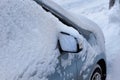 A car is covered by snow, closeup Royalty Free Stock Photo