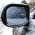 Car covered with snow, reflected in the side mirror Royalty Free Stock Photo