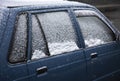 Car covered with snow on street Royalty Free Stock Photo