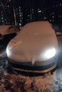 the car is covered with a thick layer of snow in the evening Royalty Free Stock Photo