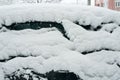 The car, covered with thick layer of snow. Negative consequence of heavy snowfalls. the left part of the car covered Royalty Free Stock Photo