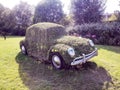 A machine overgrown with grass at the entrance of amusement park Gardaland, Italy.