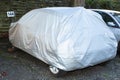 Car covered with waterproof cloth soft cover in street Royalty Free Stock Photo