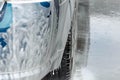 Car covered with white foam on car wash station Royalty Free Stock Photo