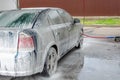 Car covered with white foam on car wash station Royalty Free Stock Photo