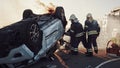 On the Car Crash Traffic Accident: Paramedics and Firefighters Rescue Injured Trapped Victims. Med Royalty Free Stock Photo