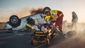 On the Car Crash Traffic Accident Scene: Paramedics Save Life of a Female Victim Lying on Stretche Royalty Free Stock Photo