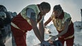 On the Car Crash Traffic Accident Scene: Paramedics Saving Life of a Female Victim who is Lying on Royalty Free Stock Photo