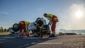 On the Car Crash Traffic Accident Scene: Team of Paramedics and Firefighters Rescue Injured People Royalty Free Stock Photo