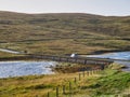 A car crosses the Bridge of Walls across Browland Voe in the west of Mainland in Shetland, Scotland, UK