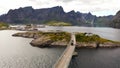 Car crossing a bridge in sunny, summer day in Reine, Lofoten, Norway - Aerial view