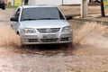 Car crossing flooded street after rains Royalty Free Stock Photo