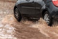 Car crossing flooded street after rains Royalty Free Stock Photo