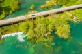 Car crossing road bridge over Mreznica river in Croatia, overhead shot of countryside landscape Royalty Free Stock Photo