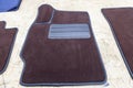 Car 3D handmade floor mats of brown color from wool for front and rear passengers of a vehicle in an interior design workshop with Royalty Free Stock Photo