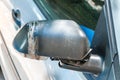 Car with damaged and broken side rear mirror glued with duct tape close up selective focus Royalty Free Stock Photo