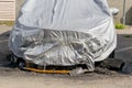 Car damaged by fire. Partially burnt cars covered with a gray film on a city street. Royalty Free Stock Photo