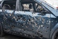 Car damaged by fragments of artillery shells the concept of killing civilians