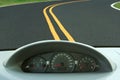Car dashboard and curvy road Royalty Free Stock Photo