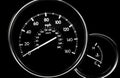 Car dashboard dials -  speedometer and engine temperature gauge Royalty Free Stock Photo