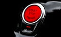 Car dashboard with focus on red engine start stop button. Modern car interior details. start/stop button. Car inside. Ignition Royalty Free Stock Photo