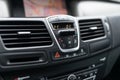 Car dashboard interior of modern car. Black cockpit with button and icon for air conditioner option, car window heating buttons an