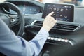 Car dashboard. Radio closeup. Woman sets up air conditioning