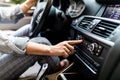 Car dashboard. Radio closeup. Woman sets up radio while driving car