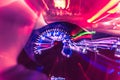 Car dashboard with speedometer on a blurred background