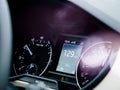 Car dashboard with speedometer showing 129 kilometres per hour Royalty Free Stock Photo
