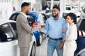 Car Dealer Giving Key To Happy Family Couple In Dealership Royalty Free Stock Photo