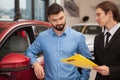 Car dealer selling new autos at the dealership Royalty Free Stock Photo