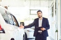 A car dealer shows a auto in a showroom. Auto business.