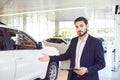 A car dealer shows a auto in a showroom. Auto business.