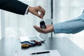 Car dealers or insurance managers cover and protect against damage and risk of driving,Hold car keys,Protecting and after-sales