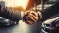 car dealership, shaking hands as they finalize a deal on a new car purchase, signifying a successful transaction Royalty Free Stock Photo