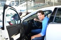 Car dealership - young handsome man sits in a car and buying a car Royalty Free Stock Photo