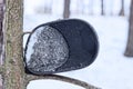 car detail from an old black metal rear view mirror with white frozen ice and snow Royalty Free Stock Photo