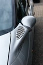 Car detail - rear view mirror of a silver car