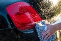 Car detailer washing auto with soap