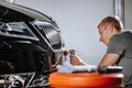 Car detailing, concept of details and polishing cars. hands of a professional car service male worker with orbital Royalty Free Stock Photo