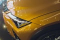 Car detailing series: Clean headlights of yellow sports car.