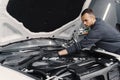 Man washing engine at the station Royalty Free Stock Photo