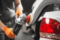 Car detailing series: polishing white vehicle in auto repair shop.