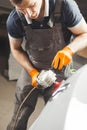 Car detailing series: polishing white vehicle in auto repair shop.